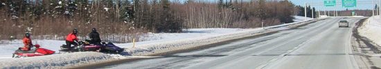Snowmobiles beside Trans Canada Highway 1 in New Brunswick